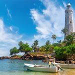 White lighthouse Dondra Head and tropical palms, Sri Lanka, near Matara.